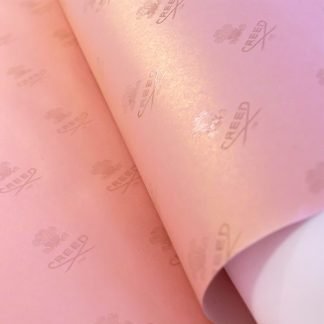 bespoke wrapping paper in pink with creed logo